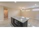 Kitchen island with granite countertop, dark cabinetry, and built-in microwave at 15936 W Kino Dr, Surprise, AZ 85374