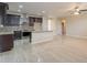 Open-concept kitchen with granite counters, stainless steel appliances, breakfast bar, and dark wood cabinets at 15936 W Kino Dr, Surprise, AZ 85374