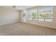 Bright, carpeted living room with large windows offering ample natural light at 15936 W Kino Dr, Surprise, AZ 85374