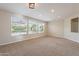 Carpeted living room with large windows providing ample natural light at 15936 W Kino Dr, Surprise, AZ 85374