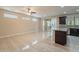 Open-concept living room featuring tile floors, ample natural light, and seamless flow to the kitchen at 15936 W Kino Dr, Surprise, AZ 85374