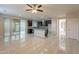 Open concept living room and kitchen area with ceiling fan and sliding door to patio at 15936 W Kino Dr, Surprise, AZ 85374