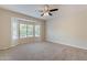 Spacious main bedroom features a bay window, soft carpet, and neutral walls at 15936 W Kino Dr, Surprise, AZ 85374