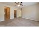 Spacious bedroom with tile flooring leads to a bathroom with glass shower and walk-in closet at 15936 W Kino Dr, Surprise, AZ 85374