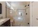 Detailed shower featuring a frameless glass door and marble and mosaic tile details at 15936 W Kino Dr, Surprise, AZ 85374