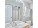 Well-lit bathroom featuring a single sink vanity, large mirror, medicine cabinet, and a toilet at 16631 E El Lago Blvd # 208, Fountain Hills, AZ 85268