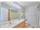 Bright bathroom featuring a double sink vanity, large mirror with lighting, and tile flooring at 16631 E El Lago Blvd # 208, Fountain Hills, AZ 85268