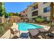 Community pool with chairs and beautiful landscaping at 16631 E El Lago Blvd # 208, Fountain Hills, AZ 85268
