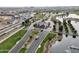 Aerial view of a gated community entrance with manicured landscaping and a serene pond at 17183 W San Marcos St, Surprise, AZ 85388