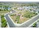 Community aerial view showcasing the surrounding landscaping, community centers, and a view of the mountains in the background at 17183 W San Marcos St, Surprise, AZ 85388