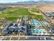 Stunning aerial view showcasing a community pool, golf course, and surrounding mountain views at 17183 W San Marcos St, Surprise, AZ 85388