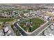 Overhead view of community featuring lush green spaces, waterways, and organized neighborhood streets at 17183 W San Marcos St, Surprise, AZ 85388
