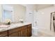 Bathroom featuring vanity with granite countertop and tub and shower combo at 17183 W San Marcos St, Surprise, AZ 85388