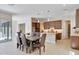 Open-concept dining area next to the kitchen features modern lighting and easy access to the patio at 17183 W San Marcos St, Surprise, AZ 85388