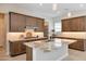 Modern kitchen with stainless steel appliances, granite countertops, and a central island at 17183 W San Marcos St, Surprise, AZ 85388