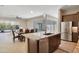 Spacious kitchen with a granite island, stainless appliances, and an open view to the dining and living areas at 17183 W San Marcos St, Surprise, AZ 85388