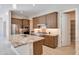 Well-lit kitchen featuring ample cabinet space, modern appliances, and a convenient pantry at 17183 W San Marcos St, Surprise, AZ 85388