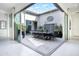 Inviting outdoor patio featuring decorative water feature, dining set, and string lights, easily accessible via sliding glass doors at 17183 W San Marcos St, Surprise, AZ 85388
