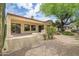 Inviting backyard with a covered patio, desert landscaping, and mature shade trees, perfect for outdoor enjoyment at 19803 N Desert Song Ct, Surprise, AZ 85374