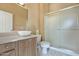 Well-lit bathroom featuring a vanity with an oval sink, walk-in shower, and tiled floor at 19803 N Desert Song Ct, Surprise, AZ 85374