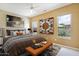Bright bedroom with stylish decor, comfortable bed, and a relaxing ambiance filled with natural light from the windows at 19803 N Desert Song Ct, Surprise, AZ 85374