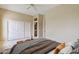 Spacious primary bedroom with ceiling fan, double closets, and ensuite bathroom access at 19803 N Desert Song Ct, Surprise, AZ 85374