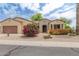 Charming single-story home featuring desert landscaping, a two-car garage, and a welcoming entrance at 19803 N Desert Song Ct, Surprise, AZ 85374