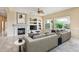 Inviting living room with a fireplace, built-in entertainment center, neutral color palette, and comfortable seating at 19803 N Desert Song Ct, Surprise, AZ 85374