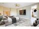 Large main bedroom suite with a ceiling fan, large tv and a large bathroom attached at 19803 N Desert Song Ct, Surprise, AZ 85374