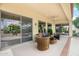 Relaxing covered patio area with comfortable seating and view to the landscaped backyard at 19803 N Desert Song Ct, Surprise, AZ 85374