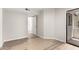 A spacious bedroom with new vinyl floors and neutral walls with a back patio door at 19820 N 13Th Ave # 175, Phoenix, AZ 85027