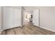 Bedroom with wood flooring and closet with slider doors leading to the kitchen at 19820 N 13Th Ave # 175, Phoenix, AZ 85027