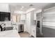 Modern kitchen featuring stainless steel appliances, white cabinetry, and quartz countertops at 19820 N 13Th Ave # 175, Phoenix, AZ 85027