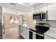 Bright kitchen features stainless appliances, island with a quartz countertop and white cabinetry at 19820 N 13Th Ave # 175, Phoenix, AZ 85027