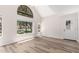Bright living room with vaulted ceiling, large window and door, and modern flooring at 19820 N 13Th Ave # 175, Phoenix, AZ 85027
