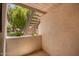 Private patio featuring textured walls, offering a serene outdoor space with views of mature trees and a metal staircase at 19820 N 13Th Ave # 175, Phoenix, AZ 85027