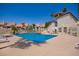Community pool with lounge chairs, surrounded by well-maintained landscaping and buildings, offering a resort-like experience at 19820 N 13Th Ave # 175, Phoenix, AZ 85027