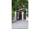 Back patio entrance featuring mature landscaping and neutral pavers creates a relaxing outdoor retreat at 2068 E Cairo Dr, Tempe, AZ 85282