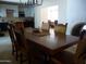 Spacious dining room, showcasing large wooden table with view into the kitchen and living room at 2068 E Cairo Dr, Tempe, AZ 85282
