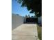 A long driveway to black privacy gate providing security and seclusion to this property at 2068 E Cairo Dr, Tempe, AZ 85282