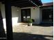 Inviting front entrance features a double door, well-maintained landscaping, and neutral stone pavers at 2068 E Cairo Dr, Tempe, AZ 85282