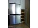 Stainless steel refrigerator and pull-out wooden shelves for efficient storage in the kitchen at 2068 E Cairo Dr, Tempe, AZ 85282