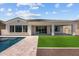 Backyard featuring sparkling pool, covered patio, and an artificial turf lawn at 21541 W Mariposa St, Buckeye, AZ 85396