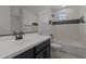 Bathroom features a dark vanity with white countertop, tile flooring and tub/shower at 21541 W Mariposa St, Buckeye, AZ 85396