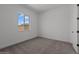 Neutral bedroom features carpet, a window, and bright white trim and doors at 21541 W Mariposa St, Buckeye, AZ 85396