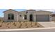 Stunning home exterior featuring a paver driveway and low-maintenance desert landscaping at 21541 W Mariposa St, Buckeye, AZ 85396