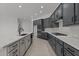 Stylish kitchen with gray cabinets, stainless steel appliances, and a large center island at 21541 W Mariposa St, Buckeye, AZ 85396