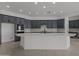 Chef's kitchen with sleek white island, stainless steel appliances, and dark cabinetry at 21541 W Mariposa St, Buckeye, AZ 85396