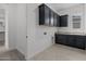 Bright laundry room with modern cabinetry, granite countertops, and tile flooring at 21541 W Mariposa St, Buckeye, AZ 85396