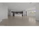 Spacious living area with tile flooring and a kitchen island with stainless appliances at 21541 W Mariposa St, Buckeye, AZ 85396